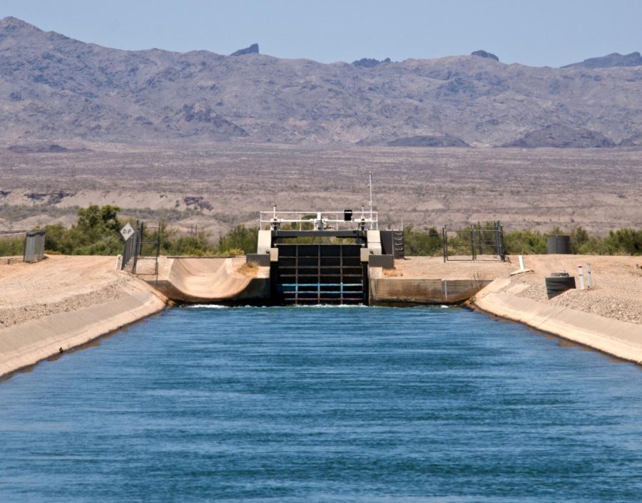 An irrigation canal running through farm country south of Parker, AZ. Image CC: Dorian Wallender (Northeast Valley News)